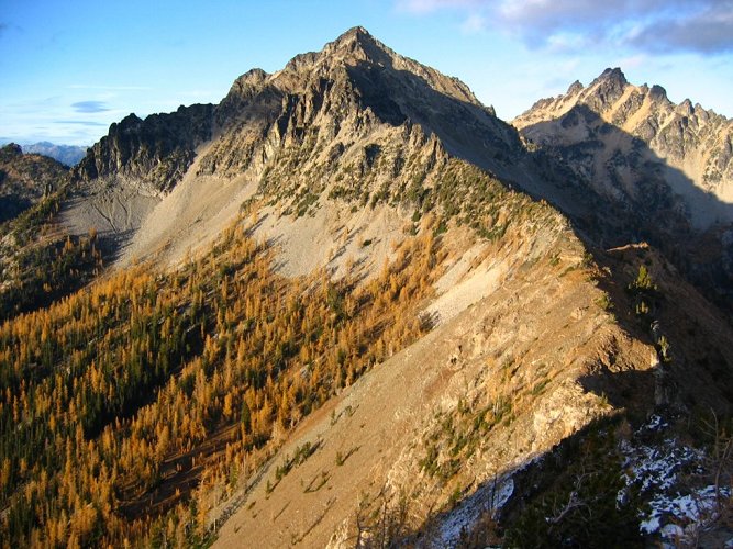 The trail from Snow Brushy Creek to Saska Pass traverses along the top edge of the larches in this picture.
To bypass some steep rocks on the right, I ended up dropped a couple hundred feet back to the larch meadows, and then climbing up the ridge.